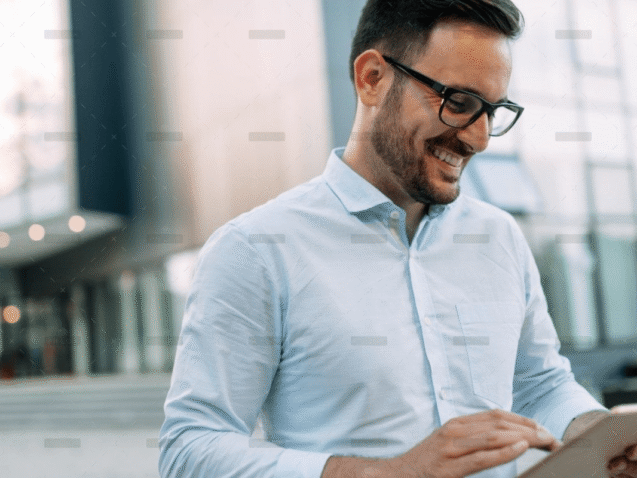 demo-attachment-609-portrait-of-businessman-in-glasses-holding-tablet-AWVHCJU